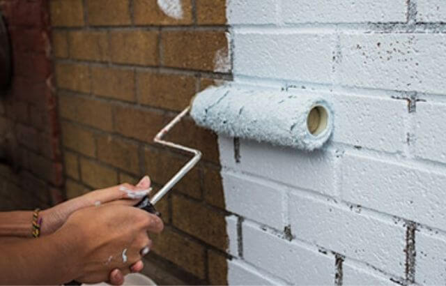 How to Decorate a Brick Wall Outside