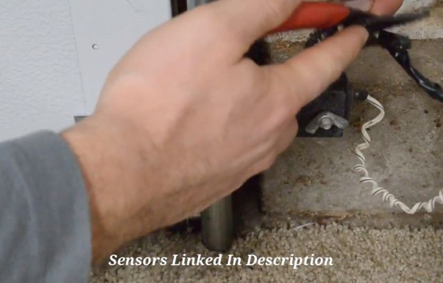 Step 1: Cut the cable to start replacing a garage door sensor