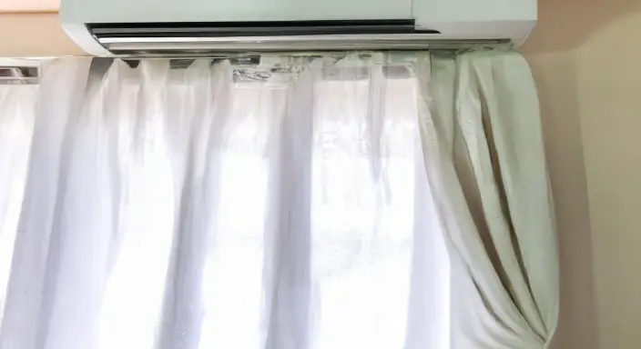 Hang a curtain to hide your AC unit