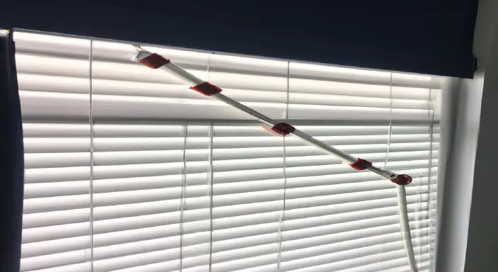Locate the cord or lift to lower the blinds 
