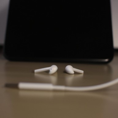 Use an audio cable to connect your TV to your AirPods. 