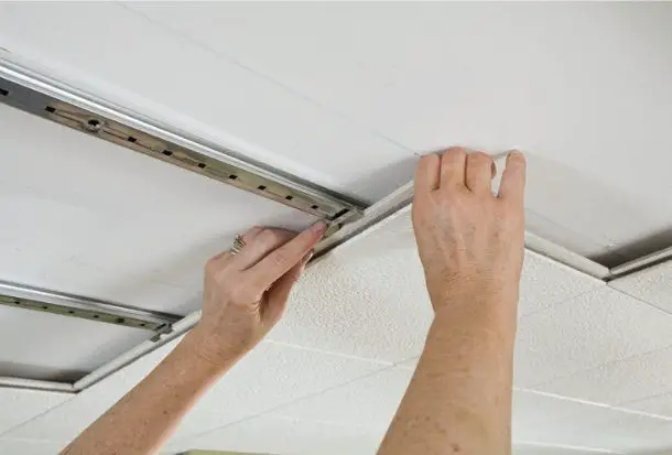 Carefully slide the tile out of its position.