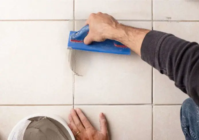 Clean the area and dispose of the tiles responsibly.