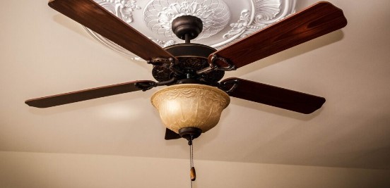 Look for a manual chain or pull cord hanging from the fan or its light fixture.
