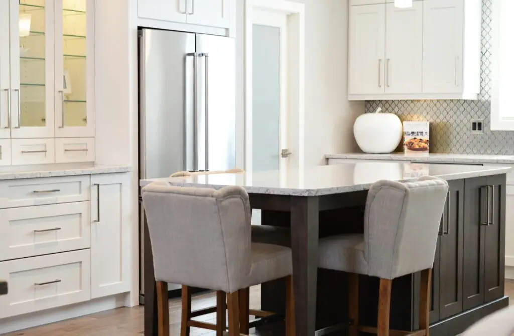 Stylish kitchen interior featuring modern design, island counter and elegant seating.