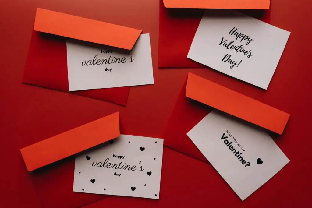 A collection of Valentine's Day cards with red envelopes on a red background.
